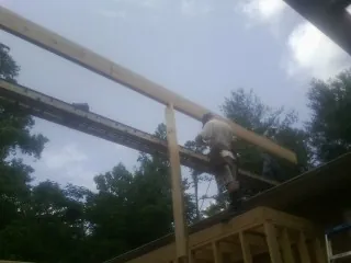 Carpenter setting a ridge beam over a new addition frame — Ice Dam Removal by Roofing Brothers in Ridgefield Park