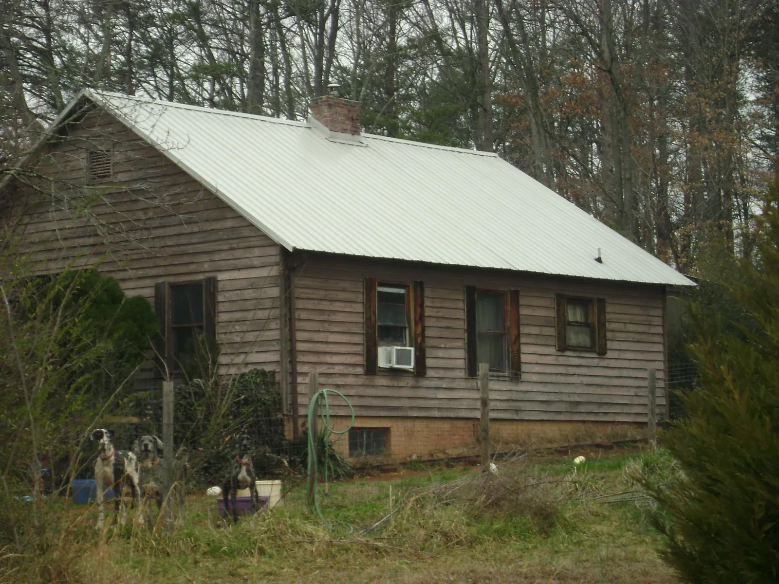 White metal roof on an old wood sided farmhouse, from a Metal Roof Installation job in Ridgefield Park
